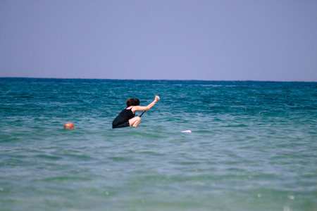 Tel Aviv Israel June 15, 2019 View of unknown Israeli people having fun on the beach of Tel Aviv in the afternoonのeditorial素材