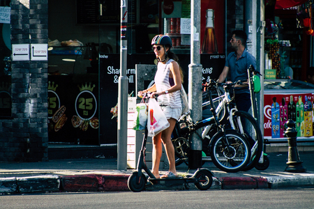 Tel Aviv Israel June 17, 2019 View of unknown Israeli people rolling with a electric scooter in the streets of Tel Aviv in the afternoonのeditorial素材