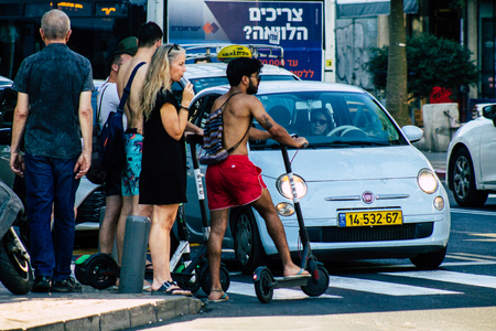 Tel Aviv Israel June 17, 2019 View of unknown Israeli people rolling with a electric scooter in the streets of Tel Aviv in the afternoonのeditorial素材