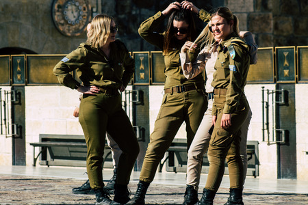 Jerusalem Israel June 19, 2019 View of young Israeli woman soldier having fun front the Western wall at the Old city of Jerusalem in the afternoonのeditorial素材