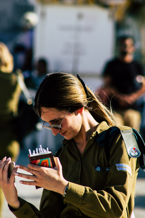 Jerusalem Israel June 19, 2019 View of young Israeli woman soldier having fun front the Western wall at the Old city of Jerusalem in the afternoonのeditorial素材