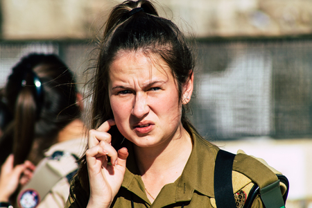 Jerusalem Israel June 19, 2019 View of young Israeli woman soldier having fun front the Western wall at the Old city of Jerusalem in the afternoonのeditorial素材