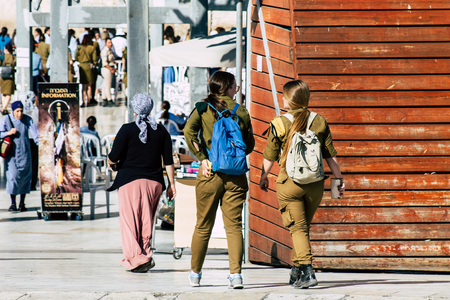 Jerusalem Israel June 19, 2019 View of young Israeli woman soldier having fun front the Western wall at the Old city of Jerusalem in the afternoonのeditorial素材