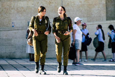 Jerusalem Israel June 19, 2019 View of young Israeli woman soldier having fun front the Western wall at the Old city of Jerusalem in the afternoonのeditorial素材
