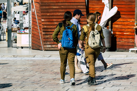 Jerusalem Israel June 19, 2019 View of young Israeli woman soldier having fun front the Western wall at the Old city of Jerusalem in the afternoonのeditorial素材
