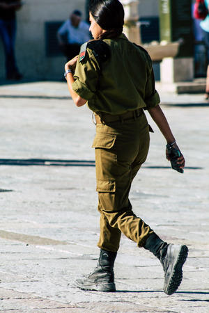 Jerusalem Israel June 19, 2019 View of young Israeli woman soldier having fun front the Western wall at the Old city of Jerusalem in the afternoonのeditorial素材