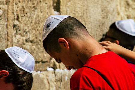 Jerusalem Israel June 19, 2019 View of young Israeli kid praying at the Western wall in the Old city of Jerusalem in the afternoonのeditorial素材