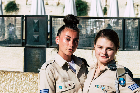 Jerusalem Israel June 19, 2019 View of young Israeli woman soldier having fun front the Western wall at the Old city of Jerusalem in the afternoonのeditorial素材