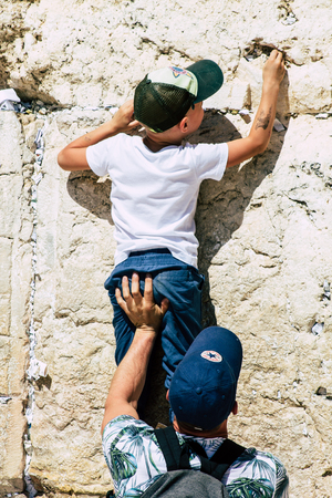 Jerusalem Israel June 19, 2019 View of young Israeli kid praying at the Western wall in the Old city of Jerusalem in the afternoonのeditorial素材