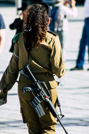 Jerusalem Israel June 19, 2019 View of young Israeli woman soldier having fun front the Western wall at the Old city of Jerusalem in the afternoonのeditorial素材