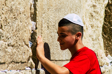 Jerusalem Israel June 19, 2019 View of young Israeli kid praying at the Western wall in the Old city of Jerusalem in the afternoonのeditorial素材