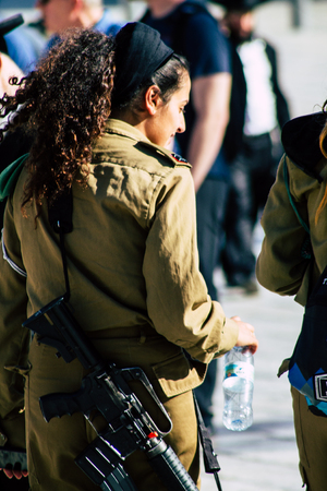 Jerusalem Israel June 19, 2019 View of young Israeli woman soldier having fun front the Western wall at the Old city of Jerusalem in the afternoonのeditorial素材