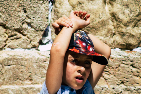 Jerusalem Israel June 19, 2019 View of young Israeli kid praying at the Western wall in the Old city of Jerusalem in the afternoonのeditorial素材