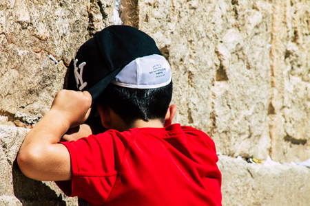 Jerusalem Israel June 19, 2019 View of young Israeli kid praying at the Western wall in the Old city of Jerusalem in the afternoonのeditorial素材