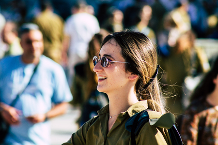 Jerusalem Israel June 19, 2019 View of young Israeli woman soldier having fun front the Western wall at the Old city of Jerusalem in the afternoonのeditorial素材