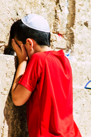 Jerusalem Israel June 19, 2019 View of young Israeli kid praying at the Western wall in the Old city of Jerusalem in the afternoonのeditorial素材