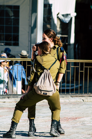 Jerusalem Israel June 19, 2019 View of young Israeli woman soldier having fun front the Western wall...