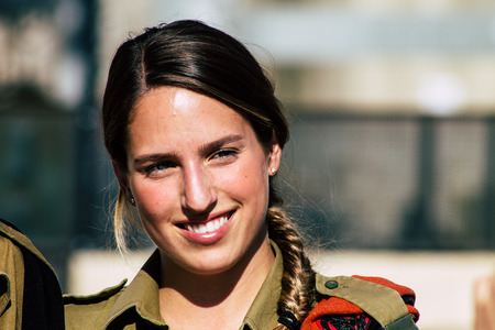 Jerusalem Israel June 19, 2019 View of young Israeli woman soldier having fun front the Western wall...