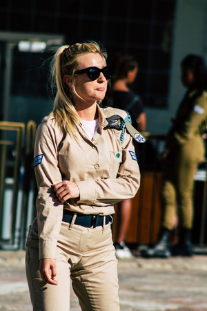 Jerusalem Israel June 19, 2019 View of young Israeli woman soldier having fun front the Western wall at the Old city of Jerusalem in the afternoonのeditorial素材