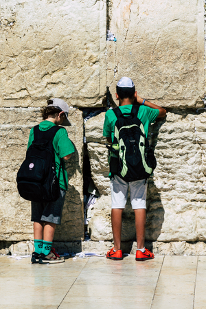 Jerusalem Israel June 19, 2019 View of young Israeli kid praying at the Western wall in the Old city of Jerusalem in the afternoonのeditorial素材