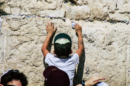 Jerusalem Israel June 19, 2019 View of young Israeli kid praying at the Western wall in the Old city of Jerusalem in the afternoonのeditorial素材