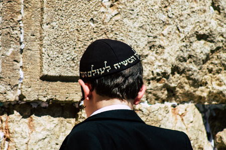 Jerusalem Israel June 19, 2019 View of young Israeli kid praying at the Western wall in the Old city of Jerusalem in the afternoonのeditorial素材