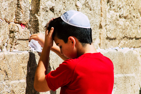 Jerusalem Israel June 19, 2019 View of young Israeli kid praying at the Western wall in the Old city of Jerusalem in the afternoonのeditorial素材