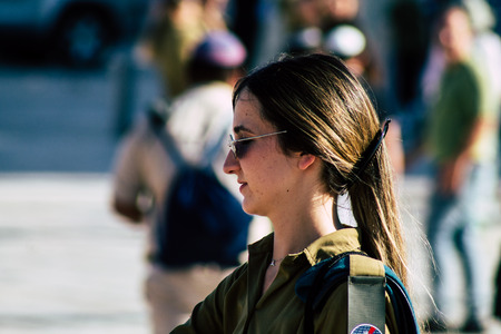 Jerusalem Israel June 19, 2019 View of young Israeli woman soldier having fun front the Western wall at the Old city of Jerusalem in the afternoonのeditorial素材