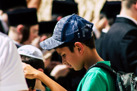 Jerusalem Israel June 19, 2019 View of young Israeli kid praying at the Western wall in the Old city of Jerusalem in the afternoonのeditorial素材