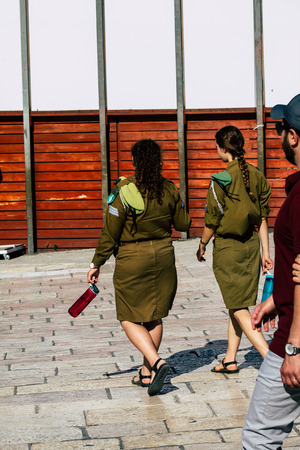 Jerusalem Israel June 19, 2019 View of young Israeli woman soldier having fun front the Western wall at the Old city of Jerusalem in the afternoonのeditorial素材