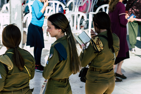 Jerusalem Israel June 19, 2019 View of young Israeli woman soldier having fun front the Western wall at the Old city of Jerusalem in the afternoonのeditorial素材