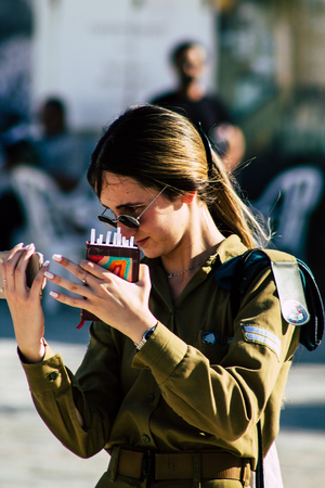 Jerusalem Israel June 19, 2019 View of young Israeli woman soldier having fun front the Western wall at the Old city of Jerusalem in the afternoonのeditorial素材