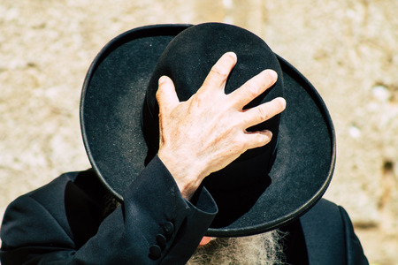 Jerusalem Israel June 19, 2019 View of unknown orthodox Israeli man praying at the Western wall in the Old city of Jerusalem in the afternoonのeditorial素材