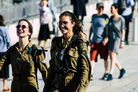Jerusalem Israel June 19, 2019 View of young Israeli woman soldier having fun front the Western wall at the Old city of Jerusalem in the afternoonのeditorial素材