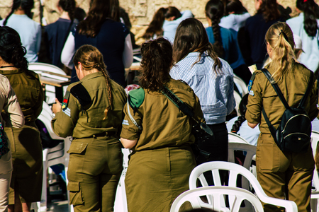 Jerusalem Israel June 19, 2019 View of young Israeli woman soldier having fun front the Western wall at the Old city of Jerusalem in the afternoonのeditorial素材