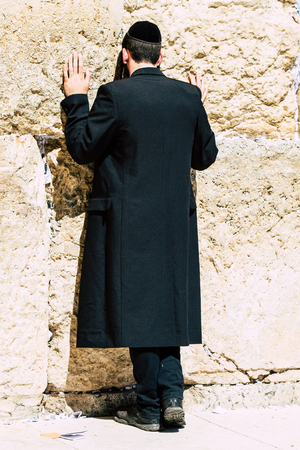 Jerusalem Israel June 19, 2019 View of unknown orthodox Israeli man praying at the Western wall in the Old city of Jerusalem in the afternoonのeditorial素材
