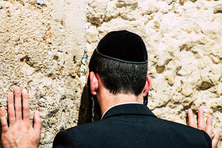 Jerusalem Israel June 19, 2019 View of unknown orthodox Israeli man praying at the Western wall in the Old city of Jerusalem in the afternoonのeditorial素材