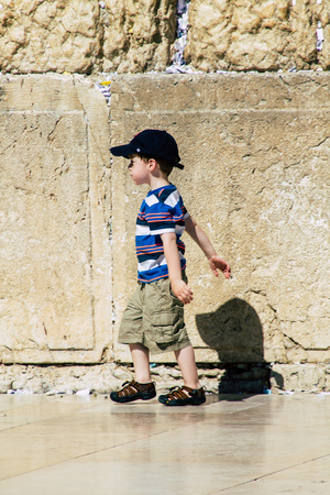 Jerusalem Israel June 19, 2019 View of young Israeli kid walking front the Western wall in the Old city of Jerusalem in the afternoonのeditorial素材