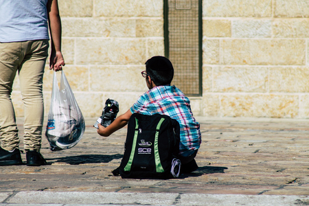 Jerusalem Israel June 19, 2019 View of young Israeli kid walking front the Western wall in the Old city of Jerusalem in the afternoonのeditorial素材