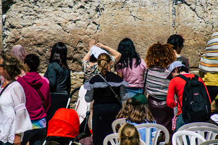 Jerusalem Israel June 19, 2019 View of unknown Israeli woman praying at the Western wall in the Old city of Jerusalem in the afternoonのeditorial素材