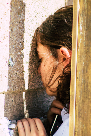 Jerusalem Israel June 19, 2019 View of unknown Israeli woman praying at the Western wall in the Old city of Jerusalem in the afternoonのeditorial素材