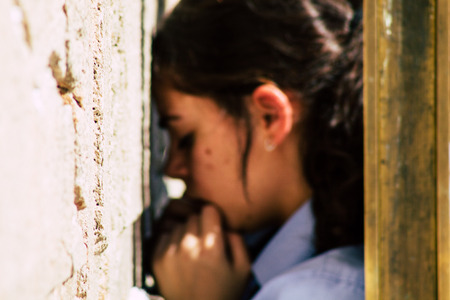 Jerusalem Israel June 19, 2019 View of unknown Israeli woman praying at the Western wall in the Old city of Jerusalem in the afternoonのeditorial素材