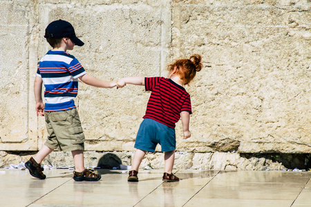 Jerusalem Israel June 19, 2019 View of young Israeli kid walking front the Western wall in the Old city of Jerusalem in the afternoonのeditorial素材