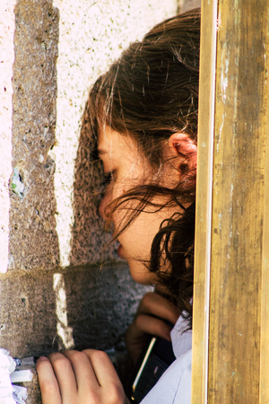 Jerusalem Israel June 19, 2019 View of unknown Israeli woman praying at the Western wall in the Old city of Jerusalem in the afternoonのeditorial素材