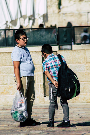 Jerusalem Israel June 19, 2019 View of young Israeli kid walking front the Western wall in the Old city of Jerusalem in the afternoonのeditorial素材