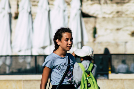 Jerusalem Israel June 19, 2019 View of young Israeli girl walking front the Western wall in the Old city of Jerusalem in the afternoonのeditorial素材