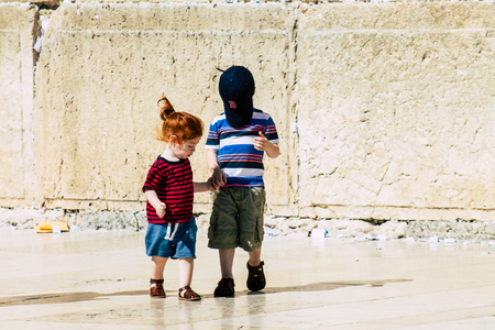 Jerusalem Israel June 19, 2019 View of young Israeli kid walking front the Western wall in the Old city of Jerusalem in the afternoonのeditorial素材