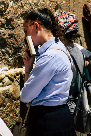 Jerusalem Israel June 24, 2019 View of unknown Israeli woman praying at the Western wall in the Old city of Jerusalem in the afternoonのeditorial素材