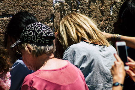Jerusalem Israel June 24, 2019 View of unknown Israeli woman praying at the Western wall in the Old city of Jerusalem in the afternoonのeditorial素材
