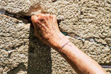 Jerusalem Israel June 24, 2019 View of unknown Israeli woman praying at the Western wall in the Old city of Jerusalem in the afternoonのeditorial素材